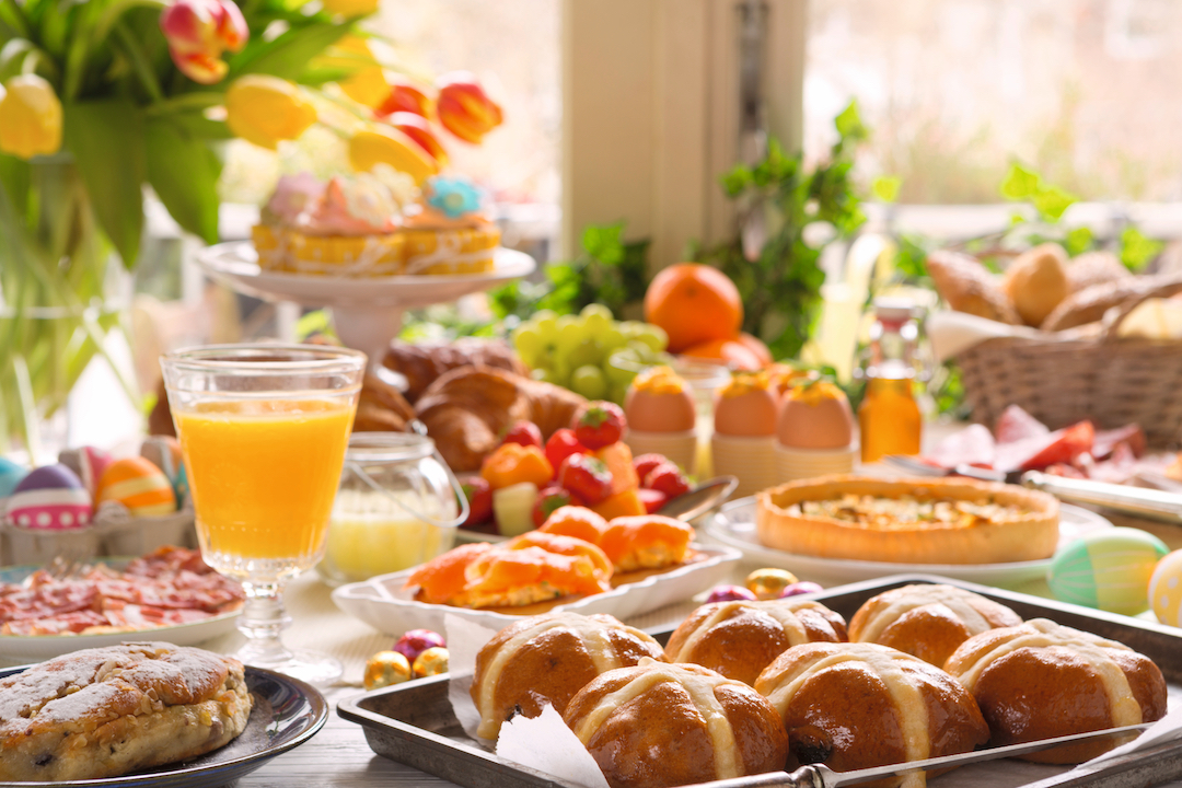 Breakfast or brunch table filled with all sorts of delicious delicatessen ready for an Easter meal.